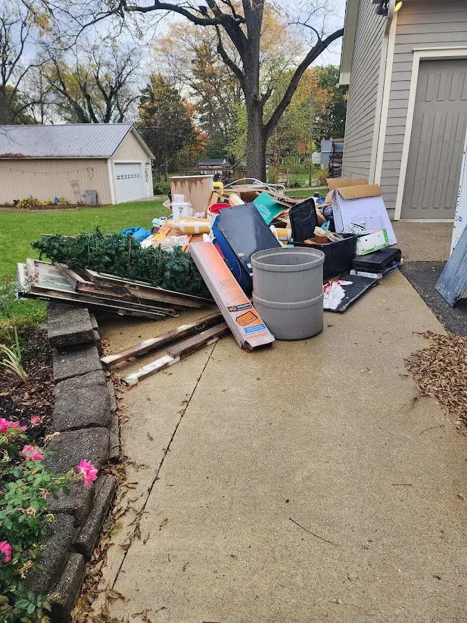 Dumpster being loaded with debris for Roofing Dumpster Rental in Eagle Grove